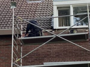 Brunssum  the Netherlands, - September 05,  2023.  Removing and Installing a  gutter of  a residential building.